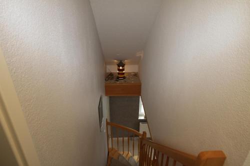 a hallway with a stairway leading to a room at Skippersin5 in Greetsiel