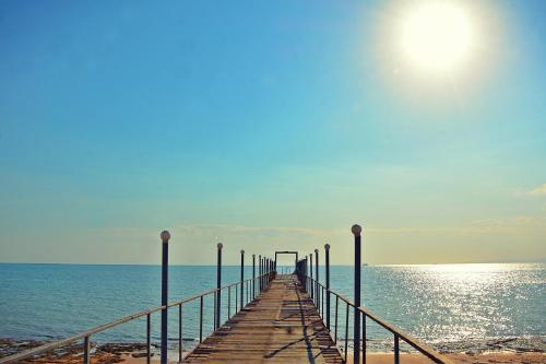 a pier stretches out into the ocean on the beach at Golden Beach 1 Ras Sedr in Ras Sedr