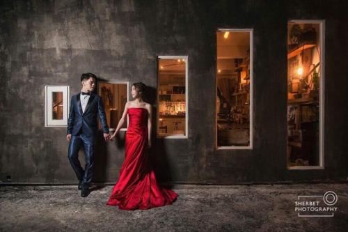 a man and a woman in a red dress holding hands at Kenting Sun Light Inn in Eluan