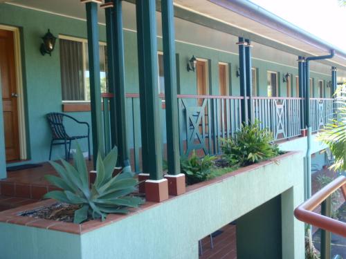 a balcony of a house with plants on it at Puffers Inn in Loganholme