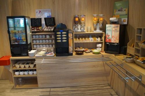 a bakery with a counter with eggs and a refrigerator at The Originals Access Aéroport, Hôtel Aurillac in Aurillac