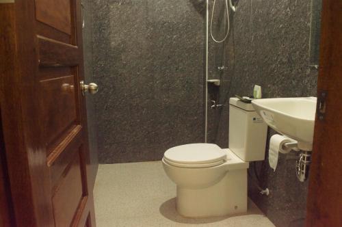 a bathroom with a toilet and a sink at Abeth's Haven in Puerto Princesa City