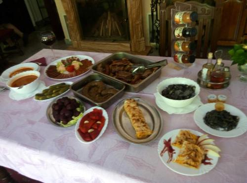 a table with many plates of food on it at Business Club Selenča in Bač
