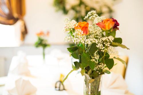 a vase filled with flowers on a table at Hotel Roko in Warsaw