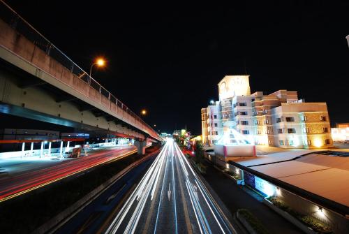 a city street at night with buildings and cars at Hotel Vanilla Komaki (Adult Only) in Komaki