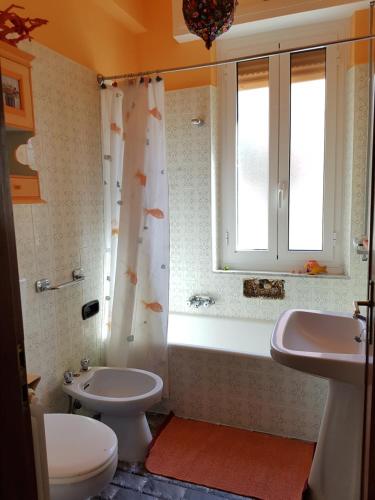 een badkamer met een toilet, een wastafel en een douche bij La Babeca in La Spezia