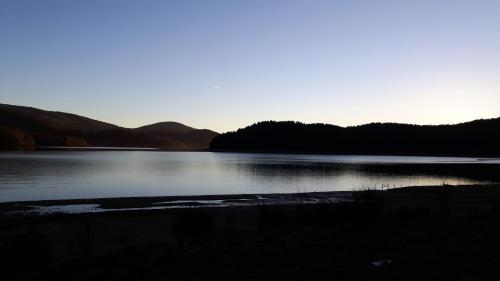 a large body of water with mountains in the background at Lorica Suite in Lorica