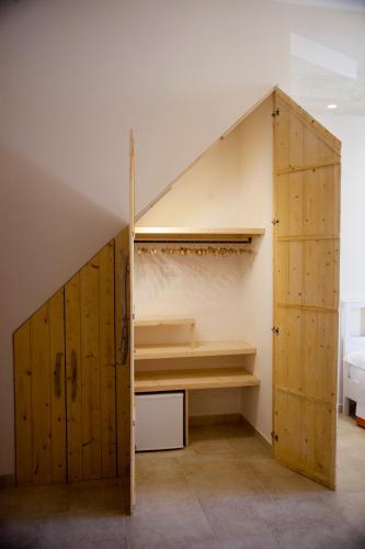 an attic room with wooden cabinets and a staircase at 3 Archi B&B in Trani