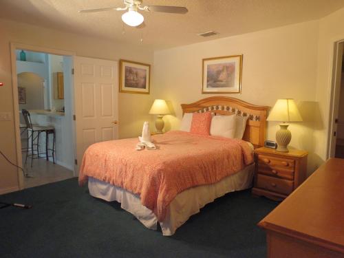 a bedroom with a bed with two stuffed animals on it at 3 Bedroom Standard Davenport Home FL 33897 in Orlando