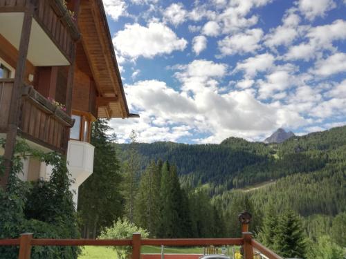 a view of the mountains from a balcony of a house at Hotel Ca' del Bosco in Selva di Cadore