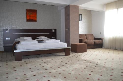 a hotel room with a bed and a couch at Hotel Premier in Sibiu