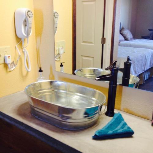 a kitchen counter with a sink in front of a mirror at HH Creek Inn in Seymour