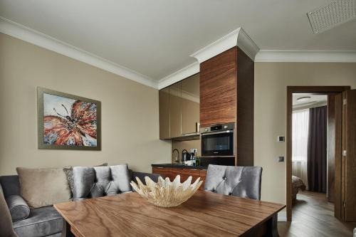 a living room with a table and a couch at Aparthotel Best Views in Krakow