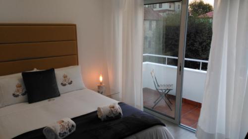 um quarto com uma cama e vista para uma varanda em ML Apartments Almada panoramic balcony no Porto