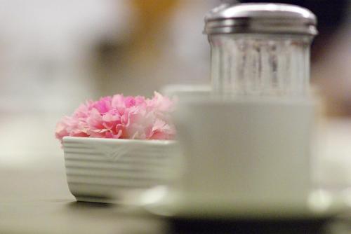 a bowl filled with pink flowers on top of a table at Cristal Palace Hotel in Buenos Aires