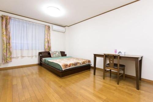 Un ou plusieurs lits dans un hébergement de l'établissement Shinjuku Apartment 102