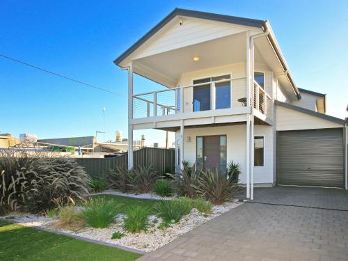 a large white house with a garage at Sunset at Snapper Point - Aldinga Beach - C21 SouthCoast Holidays in Aldinga Beach