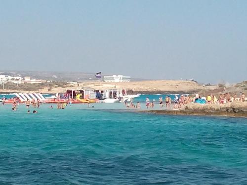 a group of people on a beach in the water at SUNSHINE APTS, TWO BEDROOM , FREE INTERNET, No 3 in Ayia Napa