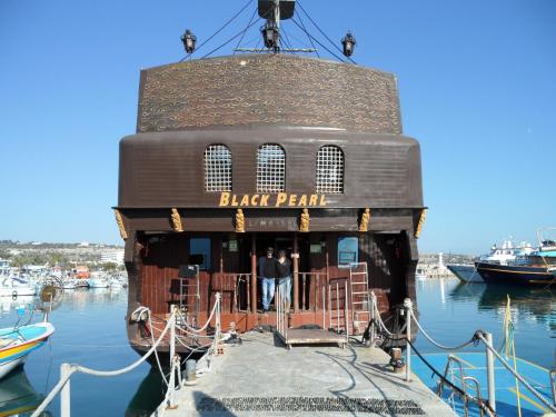 a black pearl restaurant on a boat in the water at SUNSHINE APTS, TWO BEDROOM , FREE INTERNET, No 3 in Ayia Napa