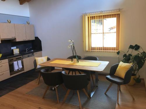 a kitchen with a table and chairs in a room at Appartement Kneisl in Sölden