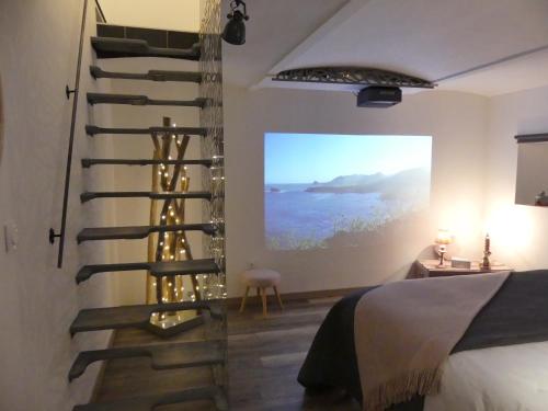 a bedroom with a spiral staircase in the wall at Entre Nous - La Poste in Saumur