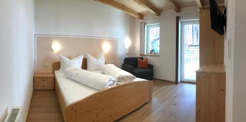 a bedroom with a large bed with white pillows at Appartement Kneisl in Sölden