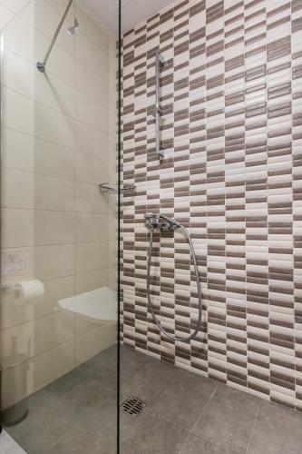 a shower with a glass door in a bathroom at Evdokia Suites in Gouves