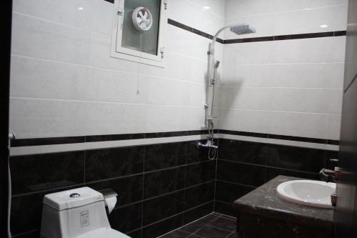 a bathroom with a toilet and a sink at Capital residence in Riyadh