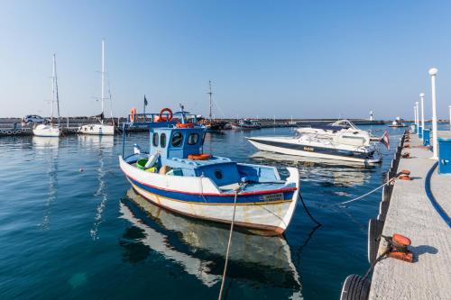 a boat is docked at a dock with other boats at Evdokia Suites in Gouves