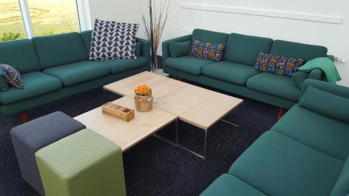 a living room with two couches and a coffee table at OnlySleep Oksebrovej in Slagelse
