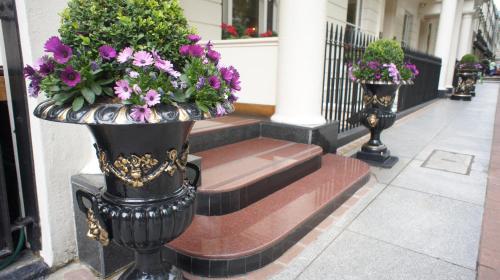 a group of flowers in vases on a building at Abbey Court Hotel - Hyde Park in London