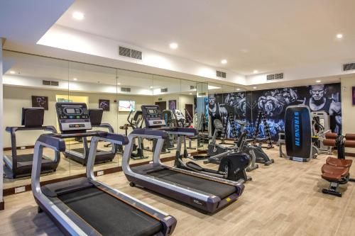a gym with several treadmills and cardio equipment at Aspire Tower in Manama