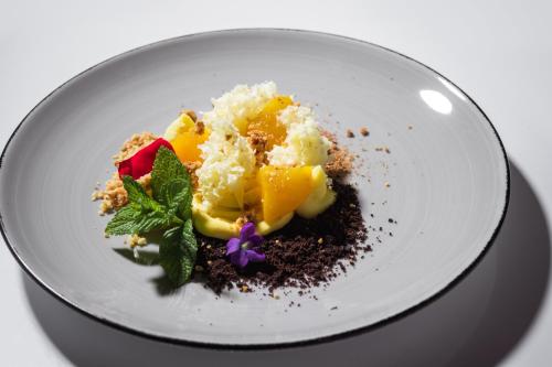 a white plate with a dessert on a table at Boutique Hotel San Rocco in Brtonigla