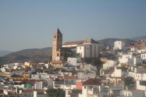 a town with a church on top of a hill at La Casa de Las Titas in Vélez-Málaga