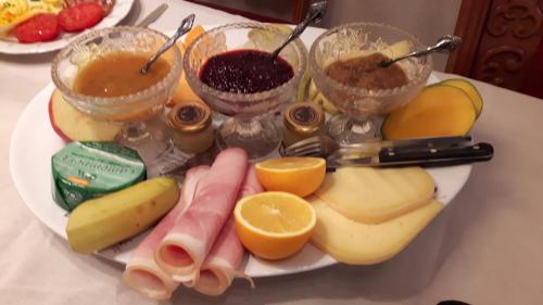 a plate of food with bananas oranges and other foods at B&B Haere Mai in Loker