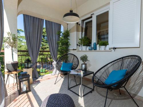 a patio with chairs and a table with blue pillows at Dream Istria Holiday in Poreč