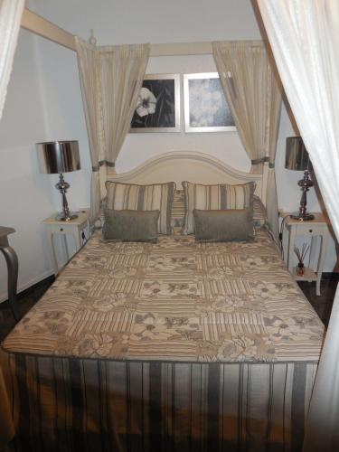 a bedroom with a large bed with two night stands at San Cristobal in Villahermosa