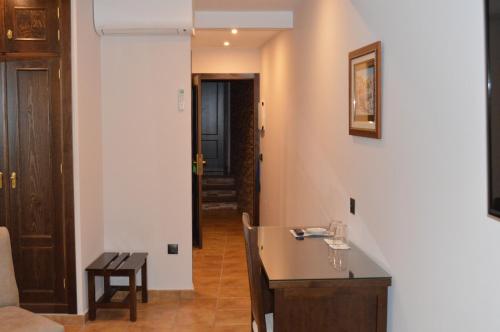 a kitchen with a sink and a table in a room at Hotel Don Javier in Ronda