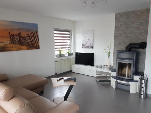 a living room with a couch and a fireplace at Ferienwohnung Ulmrich in Kesselbach