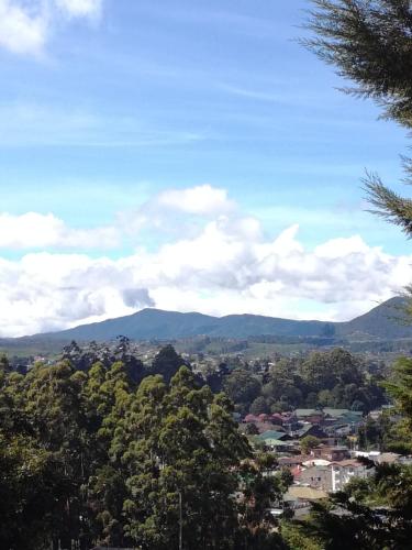 a view of a city with mountains in the distance at Sincere Wilderness Home stay in Nuwara Eliya