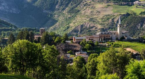 a small town on a hill with a mountain at La Pietra Felice in Introd