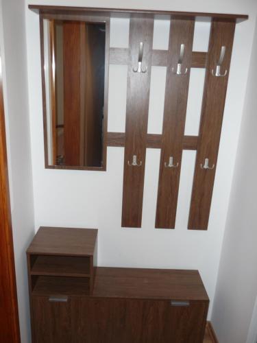 a dressing room with two mirrors and a wooden dresser at Etno domaćinstvo Milenković in Despotovac
