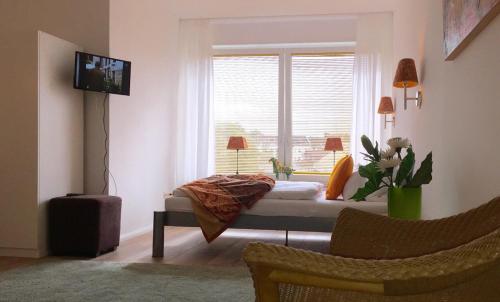 a bedroom with a bed in front of a window at Düsseldorfer Domicil Media Harbour in Düsseldorf