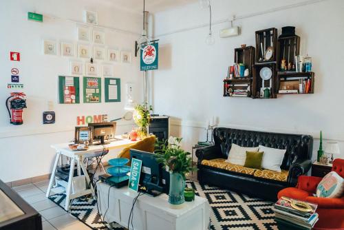 a living room with a couch and a table at Dona Fina Guest House in Mirandela
