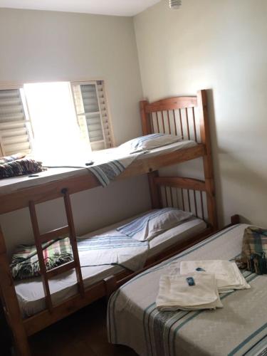 two bunk beds in a room with a window at Hotel Santa Rita in Aparecida
