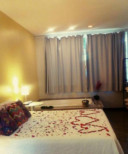 a bedroom with a large bed with flowers on it at Pousada Casa das Flores in Sao Jorge