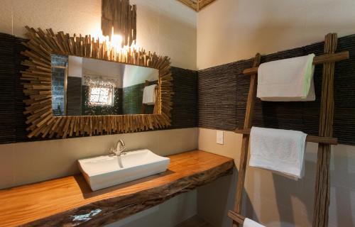 a bathroom with a sink and a mirror at Anse Severe Beach Villas in La Digue