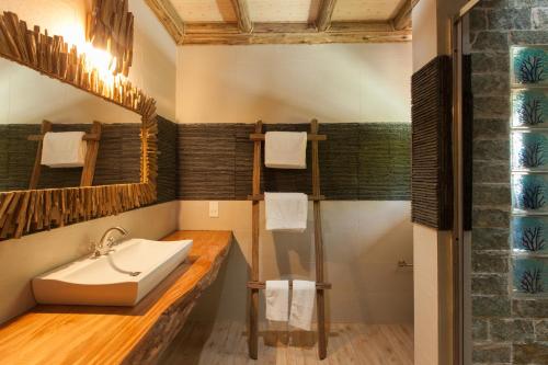 a bathroom with a sink and a shower at Anse Severe Beach Villas in La Digue