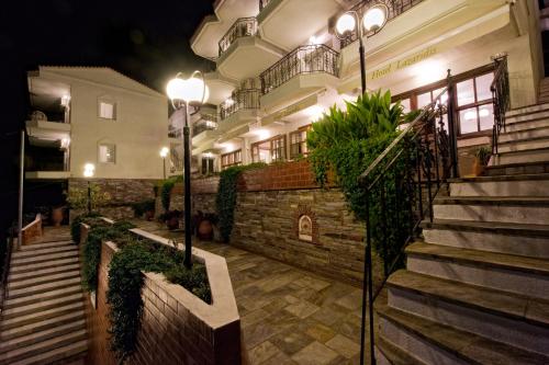 a building with stairs and lights in front of it at Lazaridis Luxury Studios & Apartments in Nea Roda