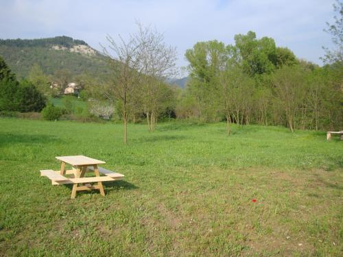a wooden picnic table sitting in a field at Villa Martina in Fermignano
